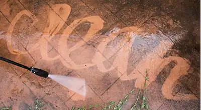 The word clean spelled out by a pressure washer nozzle